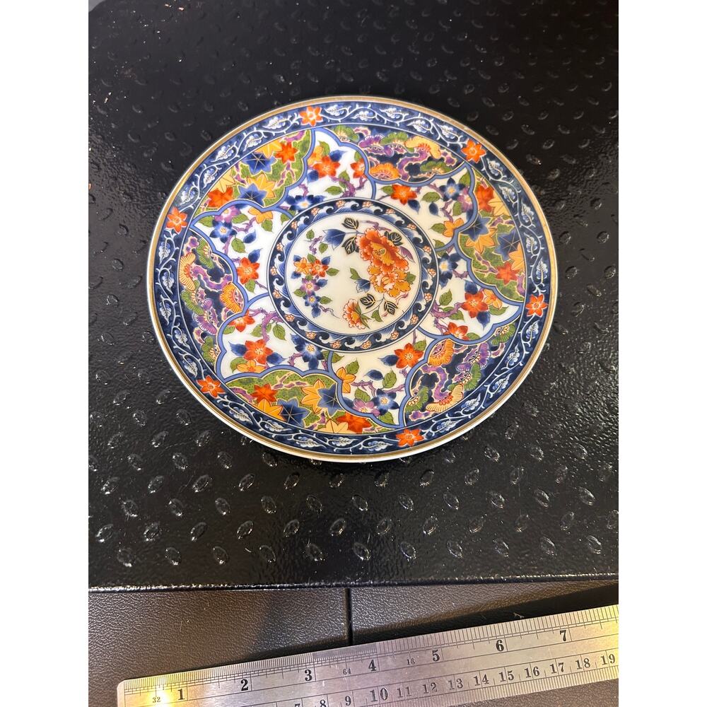 Japanese Imari porcelain plate in cobalt blue, iron-red, and gold floral pattern